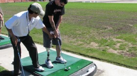 Jason Lee receives instruction from PGA professional "AB" Nevarez during Operation Game On -- a ten-week program that teaches injured servicemen and women how to play golf, in San Diego, Calif. on October 27, 2010. 