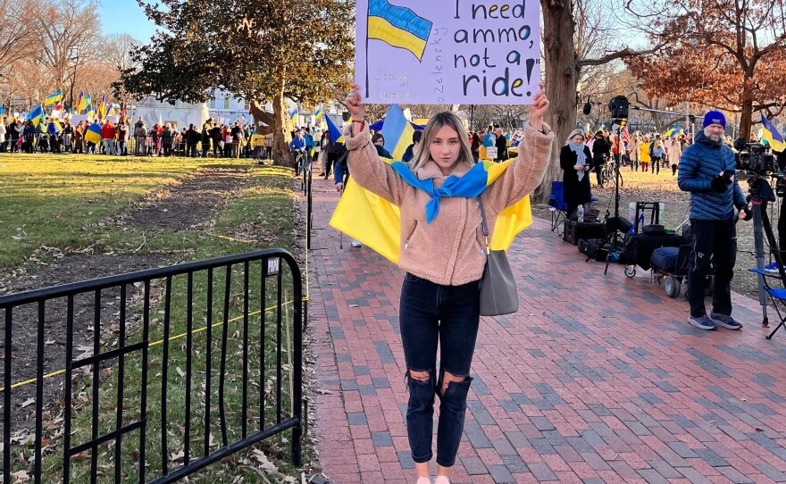 Tetiana Tytko holds a sign at a protest for Ukraine. She says she's working to help people on the ground and educate those around her.