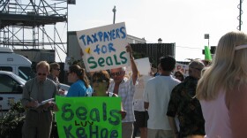 A group of seal supporters holds a rally and marches along the sidewalk on the cliff above the Children’s Pool on July 22, 2009.  