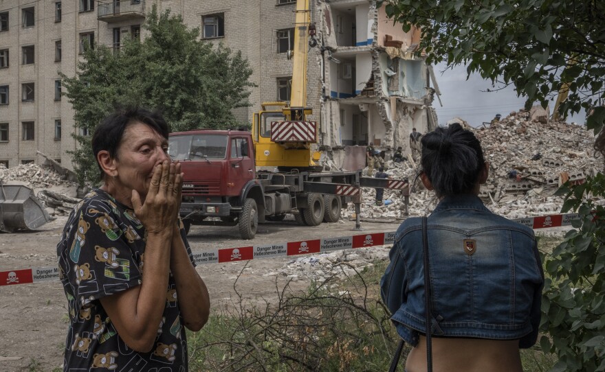 Irina Shulimova, 59, weeps at the scene of a Russian strike that hit her apartment building in eastern Ukraine.