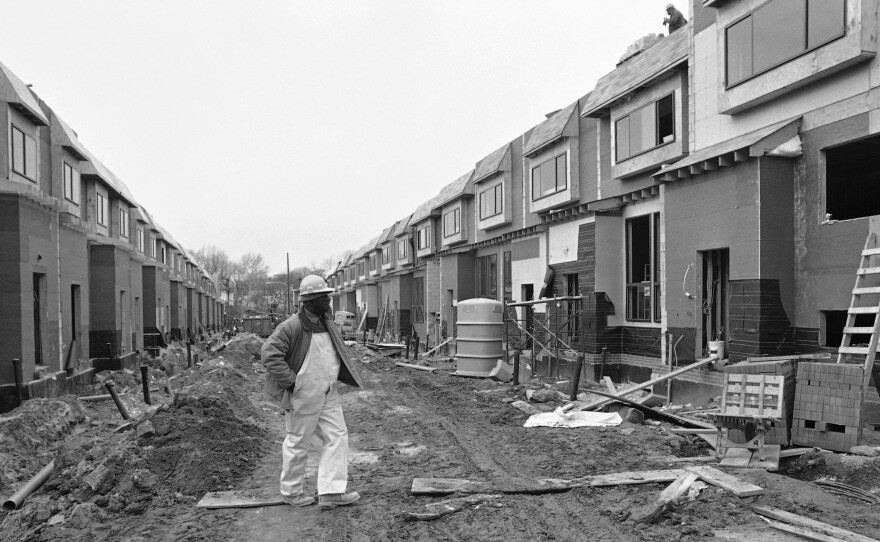 A workman walks down Osage Street, on Dec. 5, 1985 in Philadelphia as the reconstruction in the neighborhood devastated by the deadly Philadelphia police confrontation with the group MOVE continues.