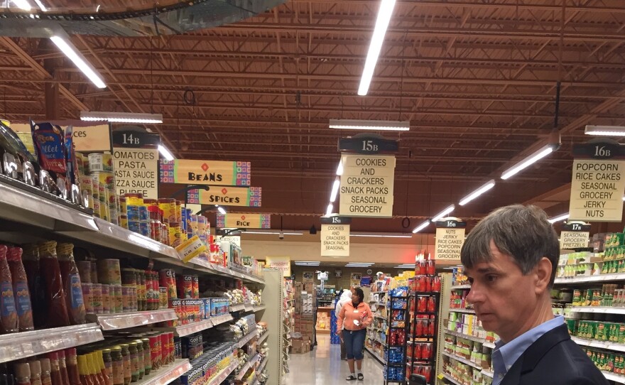 Gary Wagner, a blind Buffalo resident and subscriber to an app that connects him to a shopping assistant, looks for hot sauce at a Wegmans store in Amherst, New York.