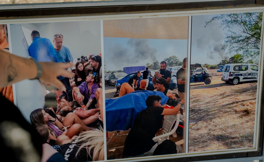 Meir Zohar points to documentary photographs at the Nova festival memorial site. The center photograph shows his wounded daughter, Bar Zohar, receiving emergency treatment in the final minutes of her life on Oct. 7, 2023.