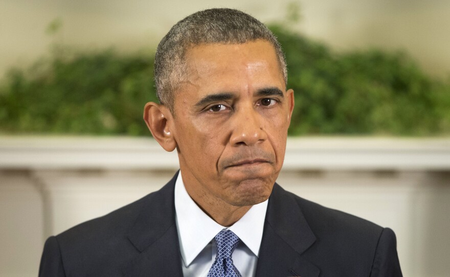 President Obama pauses as he speaks about Afghanistan on Thursday in the Roosevelt Room of the White House.