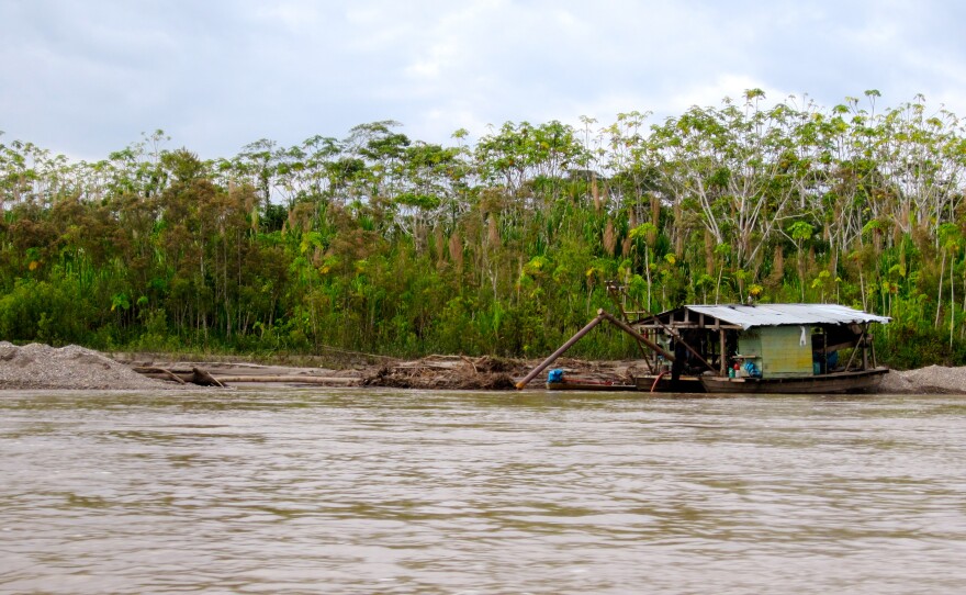 A gold-mining barge docks along the Madre de Dios river.