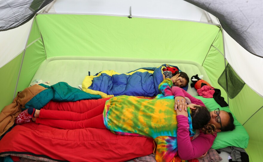 Melissa, Lola and Lola's younger sister, Izel, enjoy down time together as heavy rains restrict the family's plans while camping in Youngstown, N.Y.