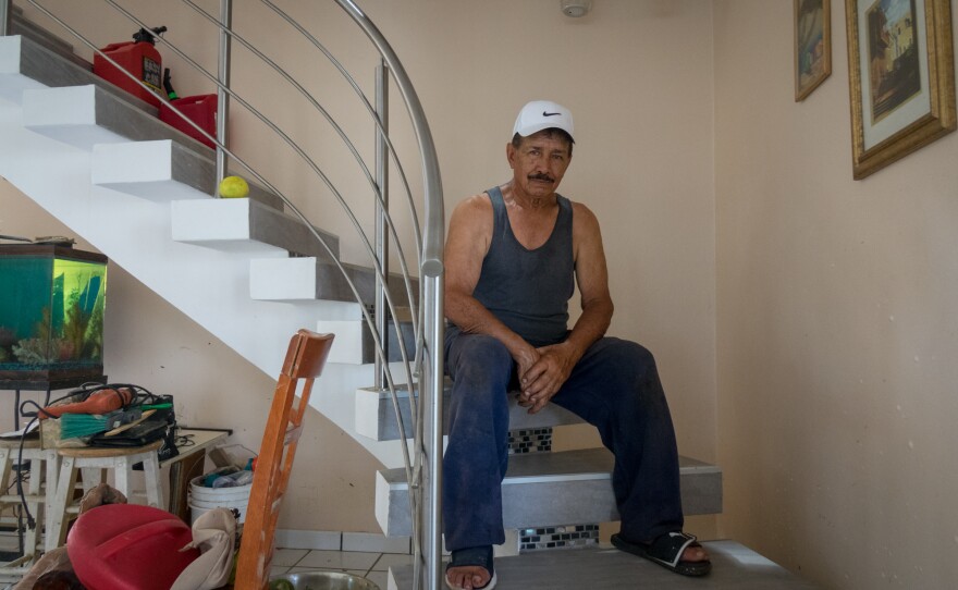 During the path of Hurricane Maria, Jose Torres kept repositioning the gas jugs behind him as the water rose inside his house. He is a diabetic and lost all his medications when his two-story house was flooded up to seven feet.