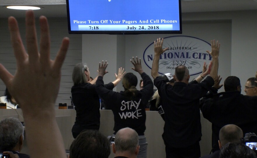 Protesters interrupt a city council meeting in National City with a die-in protest, July 25, 2018.