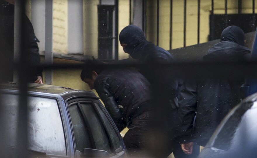 Police escort the suspects in the killing of Boris Nemtsov into a court house in Moscow, Russia, on Sunday. A total of five people have been arrested over the weekend in connection with the killing of the fierce opponent of President Vladimir Putin.