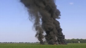 In this photo provided by Jimmy Taylor, smoke and flames rise into the air after a military transport airplane crashed in a field near Itta Bena, Miss., on the western edge of Leflore County, Monday, July 10, 2017. 