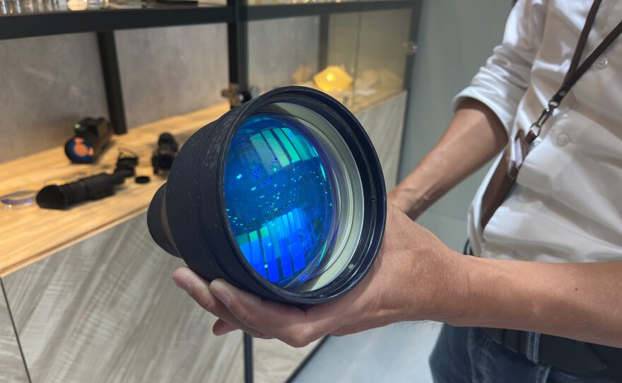 Po Sheng Lai holds up a lens made by Precise Optical.