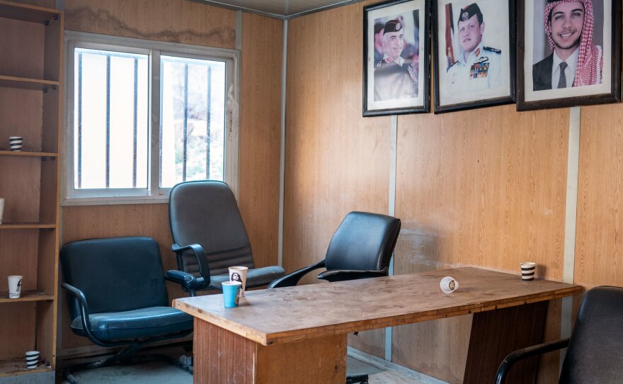 Portraits of Jordan's royal family adorn an empty guard post inside Petra. The site is now watched over by drones.