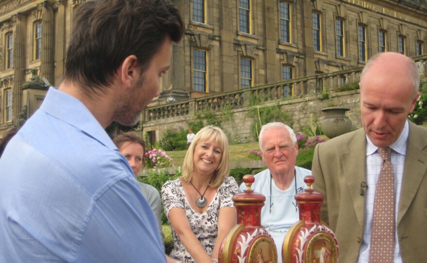 Fergus Gambon examines a pair of Ruby Bohemian Glass Vases.