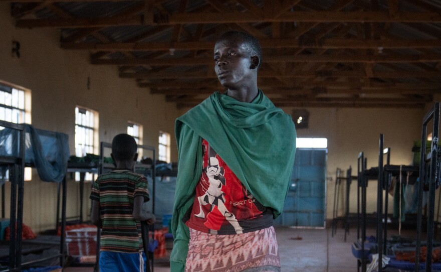 Paris stands in his dormitory at the primary school. At 15, he is starting school for the first time.