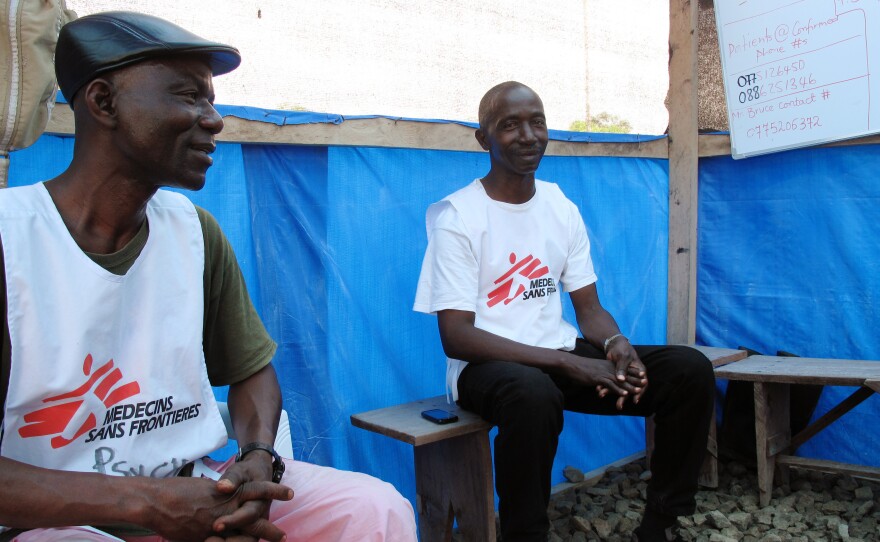 Counselors James Timothy Nah (right) and Prophet Muhammed Sano try to eases the stresses of Ebola patients and their family members.