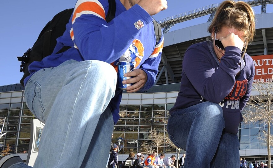 Fans "Tebow" in front of Sports Authority Field at Mile High Stadium in Denver before the start of a game between the Denver Broncos and Detroit Lions on Oct. 30, 2011.