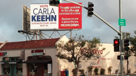 Federal prosecutor Carla Keehn, hoping to unseat Judge Lisa Schall in the June primary election, put four billboards around San Diego accusing her opponent of being a criminal, May 8, 2014.