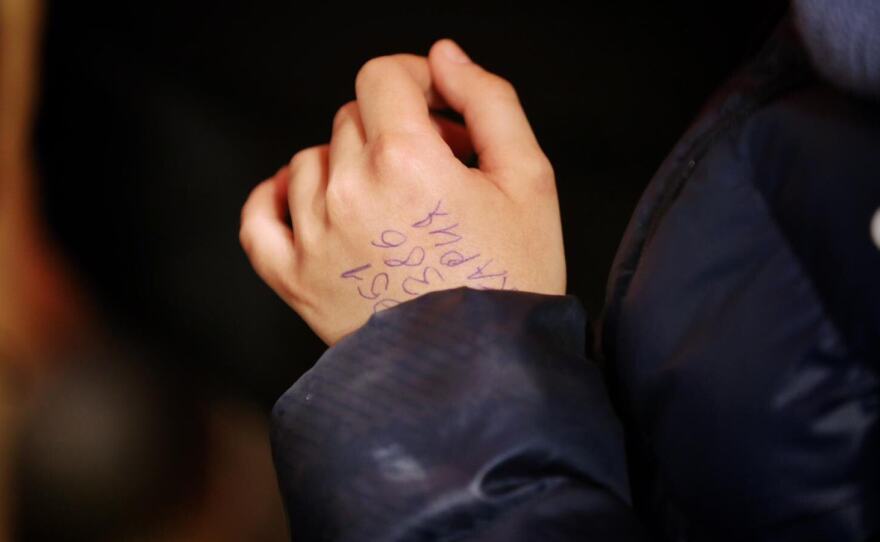 A phone number was written on Hassan's hand to help him reach relatives.