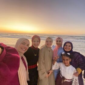 UCSD alum Dania Zanaid stands with her family on a beach in Gaza in this undated photo.