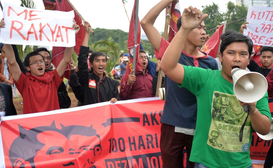 Protesters rally in front of the presidential palace in Jakarta on Jan. 28. Indonesia's new President Joko Widodo has won praise for economic reforms, but critics say he has not yet followed through on pledges to improve human rights and battle corruption.