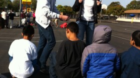 Dr. Mary Palomino talks to fifth graders at Rice Elementary in Chula Vista about walking more to get exercise while Dr. Brian Snook hands out pedometers.