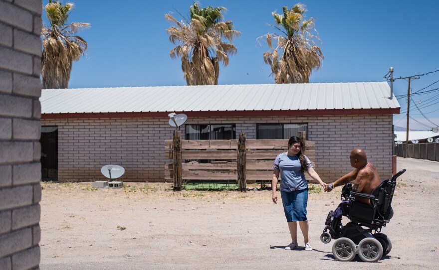 Alicia and Matt Lammers walk outside of their home in New Mexico.