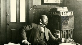 W.E.B. Du Bois seated at desk in office at Atlanta University, 1909.