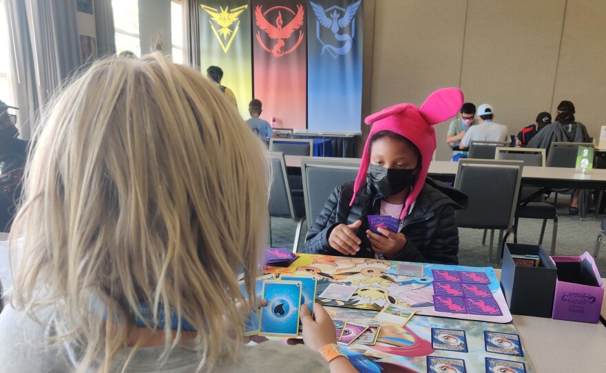 Layla Heard waits while her opponent makes a move during a Pokemon card game, July 24, 2022.