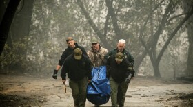 Sheriff's deputies recover the remains of a victim of the Camp Fire on Saturday, Nov. 10, 2018, in Paradise, Calif.