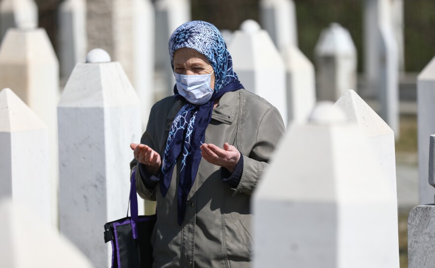 People pray at cemetery during a ceremony held the 28th anniversary of Ahmici massacre under COVID-19 measures in Vitez, Bosnia, and Herzegovina in April 2021. 116 Bosnian civilians were killed by Croatian Defence Council (HVO) during the Croat-Bosniak War in April 1993 in Ahmici village.