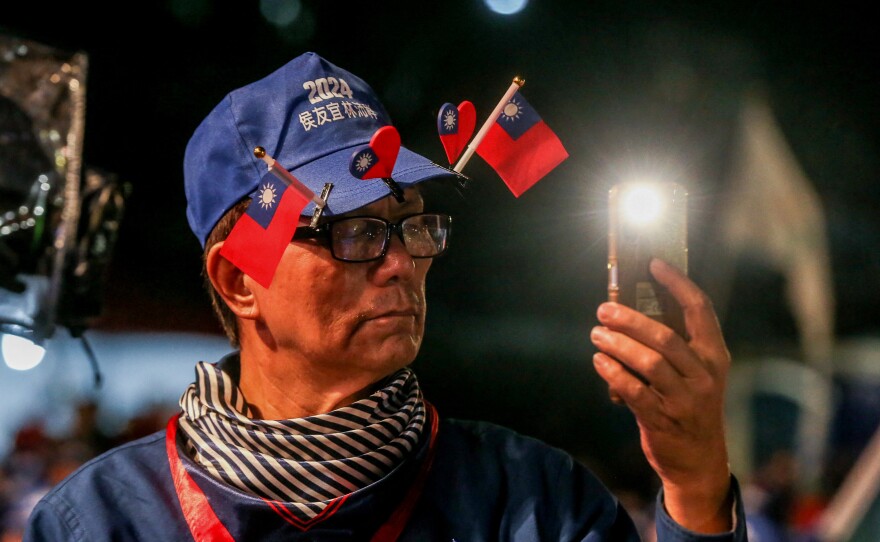 A supporter wears small Taiwan national flags on his hat during an election campaign rally of Kuomintang (KMT) on January 4.