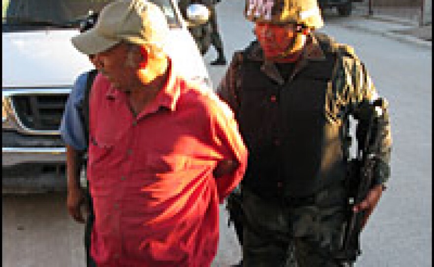 Guadalupe handcuffs a man for drinking in public. Though not the normal duties of the Mexican army, he says rounding up drunks and pulling over speeders is part of re-establishing order in Juarez, Mexico's deadliest city.