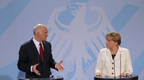 German Chancellor Angela Merkel and Greek Prime Minister George Papandreou speak during talks Tuesday in Berlin. Germany's lower house of parliament voted 523-85 to bolster the European bailout fund, which is designed to help Greece and other troubled countries.