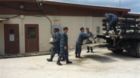 Sailors pile sandbags against the walls of Naval Security Forces headquarters at Naval Station Guantanamo Bay, Cuba, Aug. 22, 2012, in preparation for wind and rain from tropical storm Isaac. 