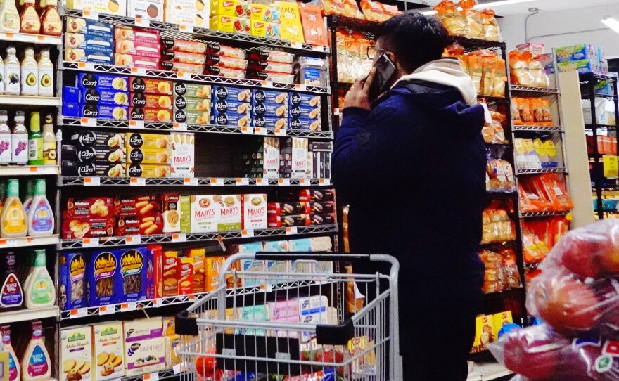 People shop at the Ideal Fresh Market in Brooklyn in New York City on Jan. 12, 2023. Inflation has eased substantially this year but still remains above the Fed's target.