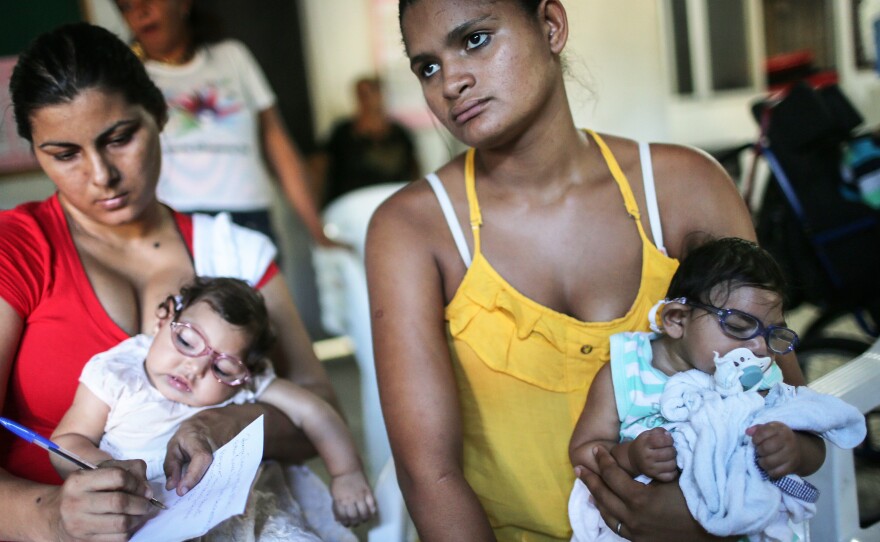 Infants born with microcephaly are held by mothers at a meeting for mothers of children with special needs in Recife, Brazil.