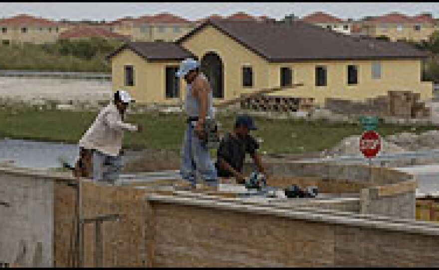 Construction workers build a house in Miami. Florida's large real estate market is in the throes of a major slump. Fears of a worsening economy have become a major campaign issue in the GOP primary.