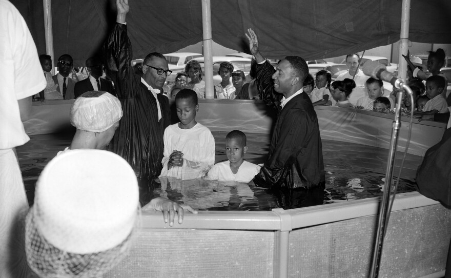 Reverend E.C. Ward of the 31st Street Seventh Day Adventist Church and Pastor Berry conduct baptism ceremonies in the Big Gospel Tent, September 1967.