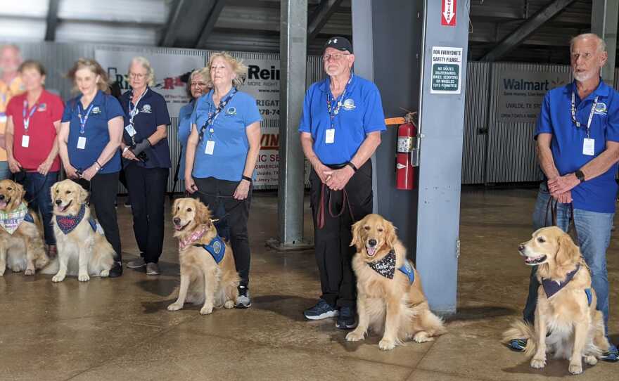 Volunteers and comfort dogs attend a vigil in Uvalde, Texas, on Wednesday.