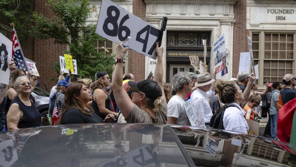 A demonstrator holds up an "8647" sign at a "No Kings" protest in Louisville, Ky., in June 2025. It's an anti-Trump slogan, with multiple interpretations.