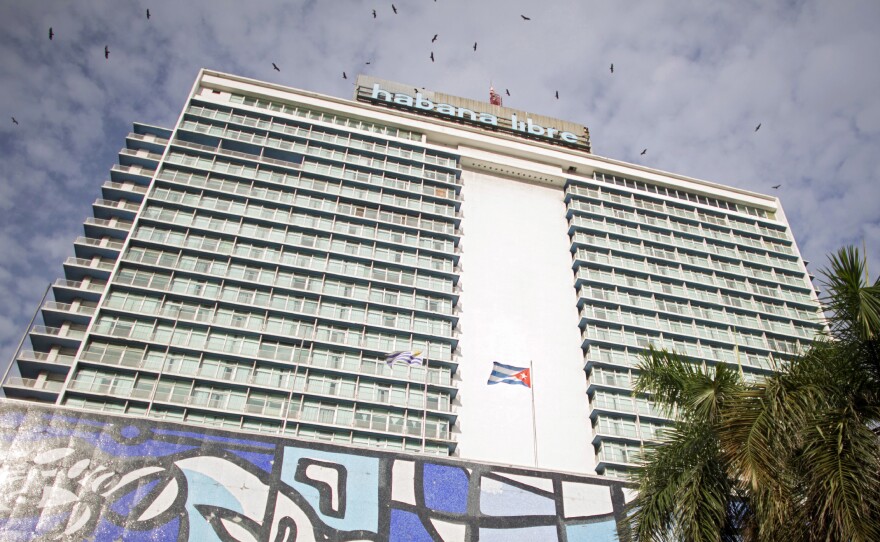 Huge cell towers top Havana's Habana Libre luxury hotel, and locals gather nearby to take advantage of the Internet access.