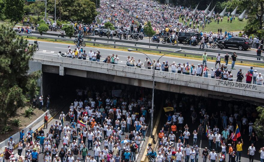 Demonstrators clog a Caracas highway on Wednesday, shouting their resistance to Maduro. The president's push to tighten his power has helped trigger deadly unrest in Venezuela.