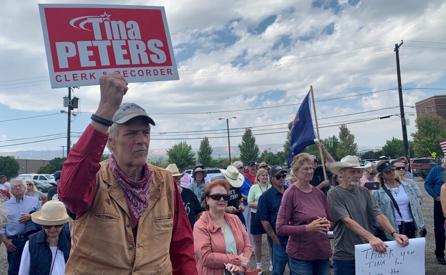 Supporters of Mesa County clerk Tina Peters appear at a rally for her last month in Grand Junction, Colo. Peters is under investigation for the unauthorized release of sensitive information about voting equipment.