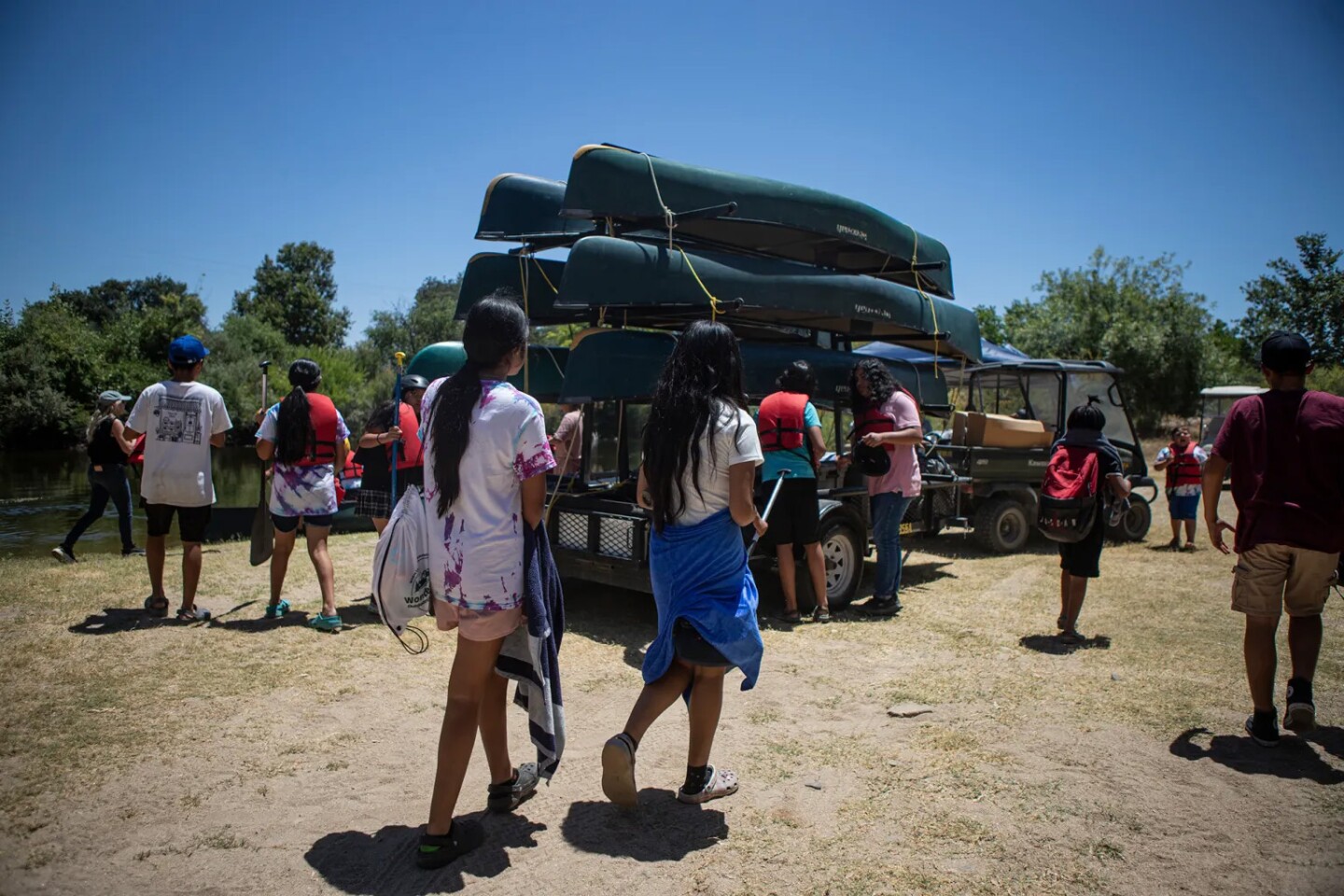 Students of the Migrant Outdoor Education Program canoe along the San Joaquin River near the Scout Island Education Center in Fresno on July 11, 2025.