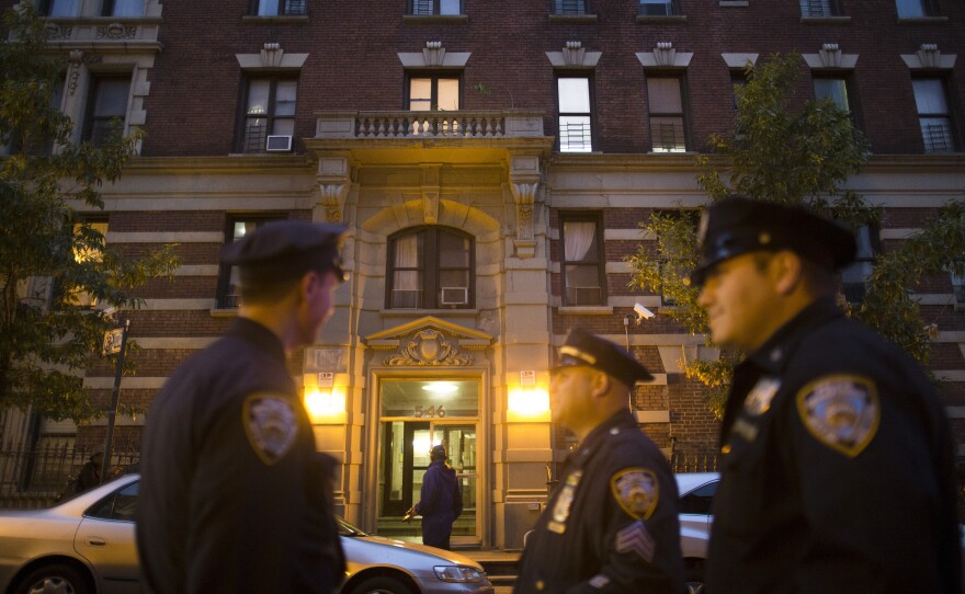 Police officers stand outside the home of Craig Spencer, a Doctors Without Borders physician who recently returned to the city after treating Ebola patients in West Africa, on Thursday in New York. Spencer tested positive for the virus, according to preliminary test results, city officials said.