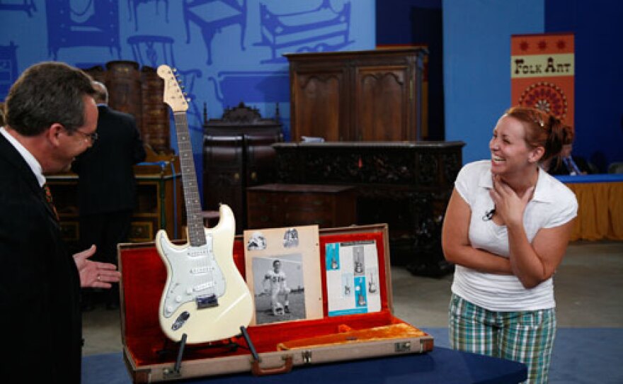Peter Shaw appraises a 1962 left-handed Olympic White Fender Stratocaster for $48,000 in Wichita, Kansas.