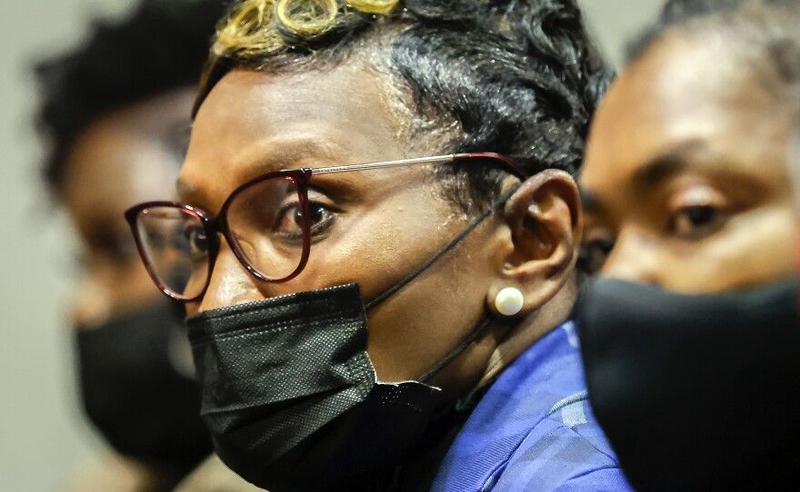 Ahmaud Arbery's mother, Wanda Cooper-Jones, reacts as Superior Court Judge Timothy Walmsley sentences Greg McMichael, Travis McMichael, and William "Roddie" Bryan in the Glynn County Courthouse.