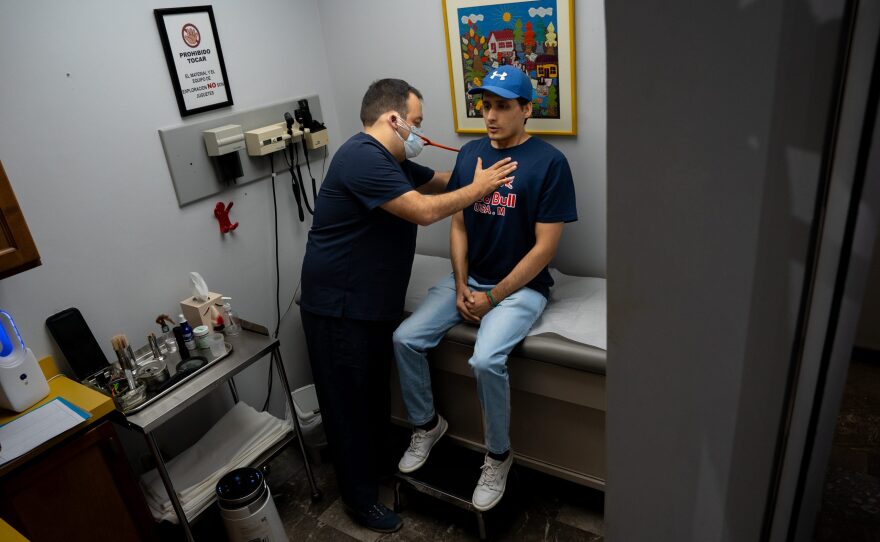 Dr. Manuel Mérida treats a patient who crossed from the U.S. to the Clínica de Asma y Alergia that he runs with his father Dr. Valente Mérida on Aug. 7, 2024.