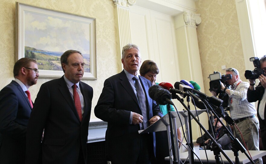 Peter Robinson, center, resigned as Northern Ireland's first minister, along with several other ministers from his party.