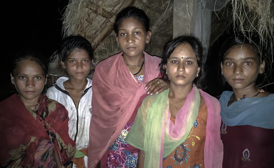 Kamala, second from the right in the green and pink scarf, with other menstruating girls by her best friend's shed.